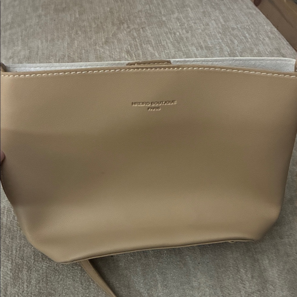 Tan purse with sleek design and smooth finish.